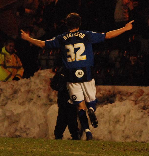 Atkinson wheels away to celebrate the first of his two goals.