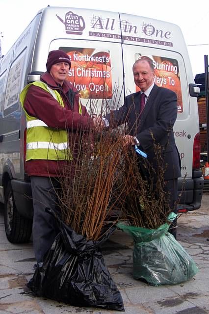 Cliff Ellison (left), of Groundwork, receives donated trees from Edward Redican, from the All-In-One Garden Centre.