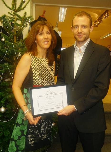 Brigit Rhodes and Oliver Hope with their award for the best Christmas window in Rochdale.