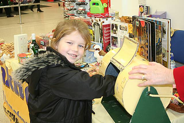 Little Emma McDonald had a go on the tombola