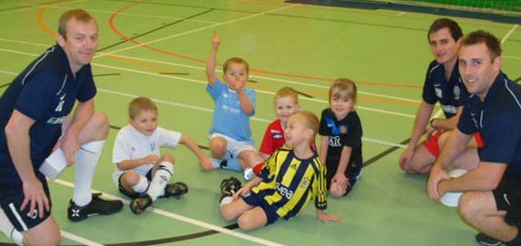 Santos Soccer School Coaches with children