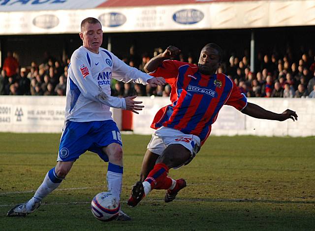 Taiwo puts a tackle in on Adams.