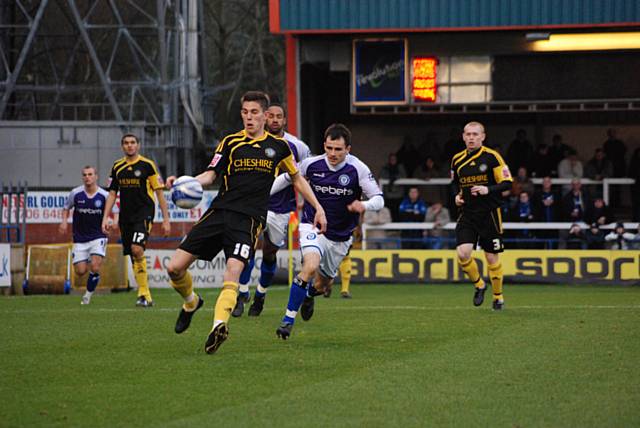 Chris Dagnall closes down Shaun Brisley.