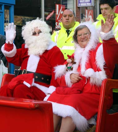 Mr and Mrs Christmas waving to the crowds of children