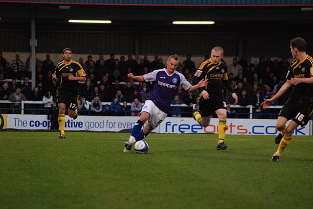 Higginbotham continues to attack the Macclesfield backline.