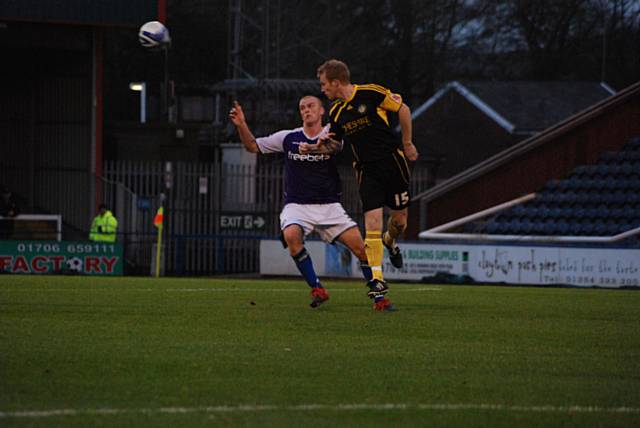 Paul Bolland heads the ball away from Jason Taylor.