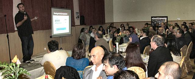 The crowd laugh along at the charity fundraiser.