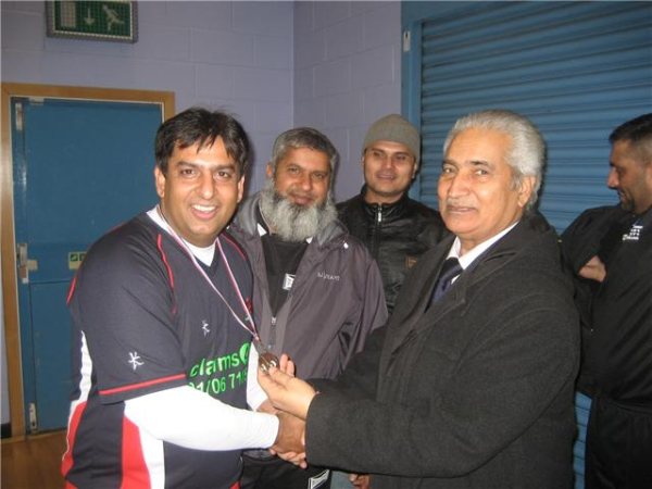 Siddique receives his MOM Medal from Gulam Rasool Shehzad.