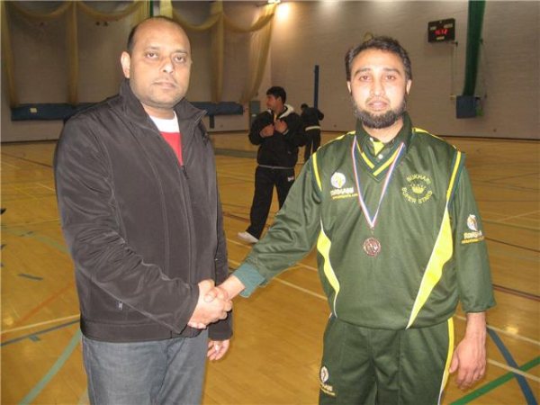 Bukhari receives his MOM Medal from Wasim of Aroosa cloth house.