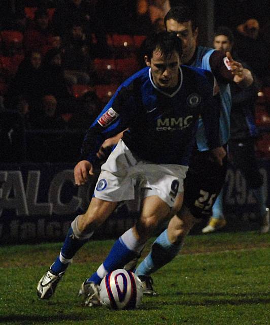 Dagnall tries to get away from Adam Nowland.