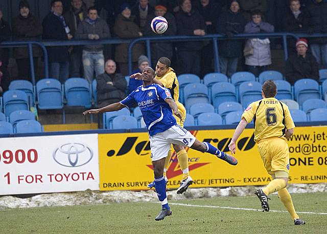 Nathan Stanton wins a header against Tom Elliott.