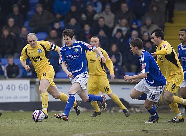 Lee Bell comes forward for Macclesfield.