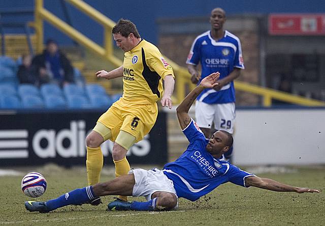 Emile Sinclair puts in a tackle on Ciaran Toner.