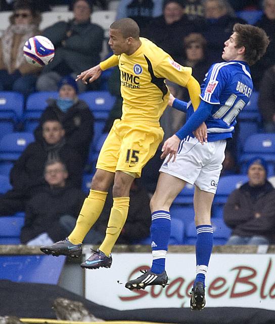 Thompson heads the ball down in front of Shaun Brisley.