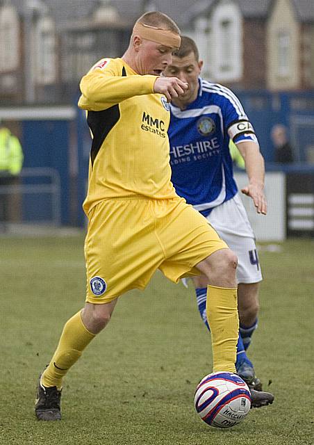 Nicky Adams holds the ball away from Sean Hessey.