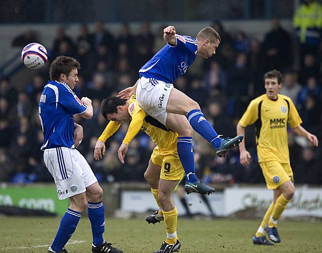 Chris Dagnall comes under a robust challenge.