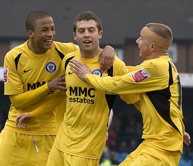 Thompson and Adams join the Dale goalscorer's celebrations.