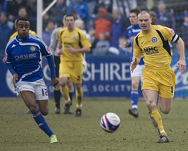 Gary Jones and Reid chase the ball down.