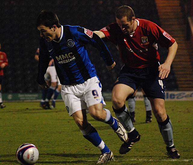 Chris Dagnall keeps the ball away from David Artell.