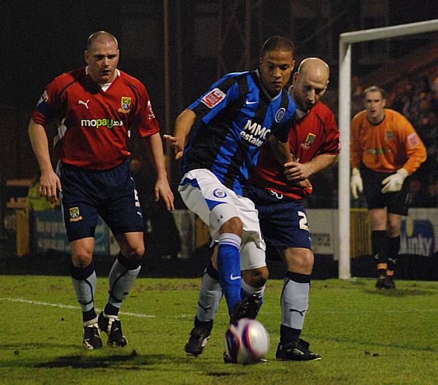 Joe Thompson holds the ball up in the Morecambe box.