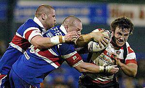 Chris Baines keeps Oldham going forward through the Hornets tackles.