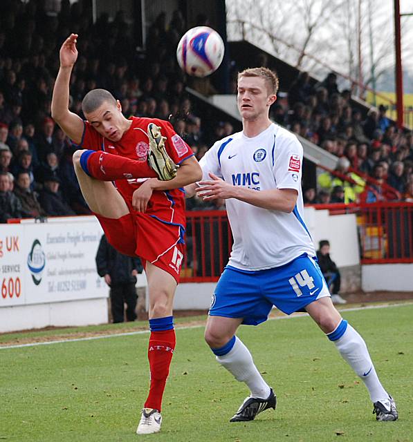 Kirk Hudson hooks the ball clear from Scott Wiseman.