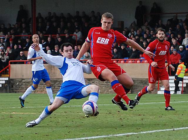 Chris Dagnall gets in front of Rhys Day to shoot.