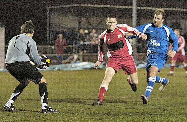 Chris Cooper shields the ball from a Station Road attacker.