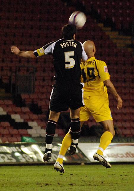 Steve Foster wins a header against Lee Thorpe.