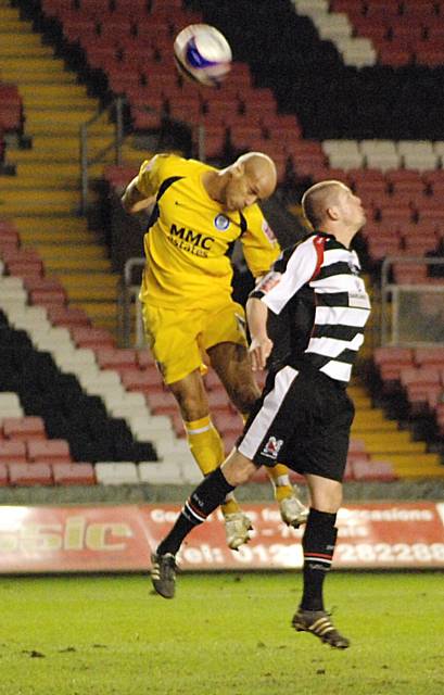 Thorpe challenges Alan White for an aerial ball.