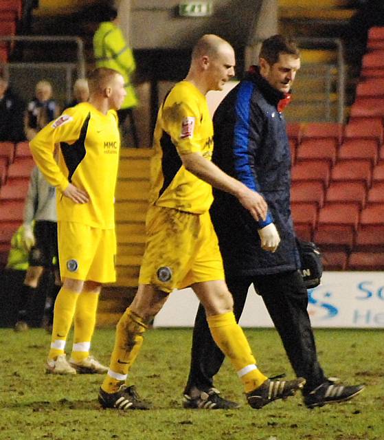 Gary Jones is forced off alongside Dale physio Andy Thorpe in Tuesday night's game at Darlington.