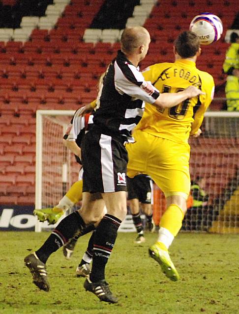 Le Fondre chests the ball down under pressure from White.