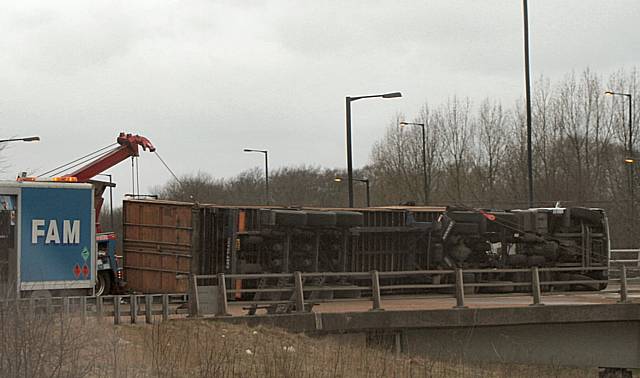 The overturned lorry on the motorway bridge of the A627(M).