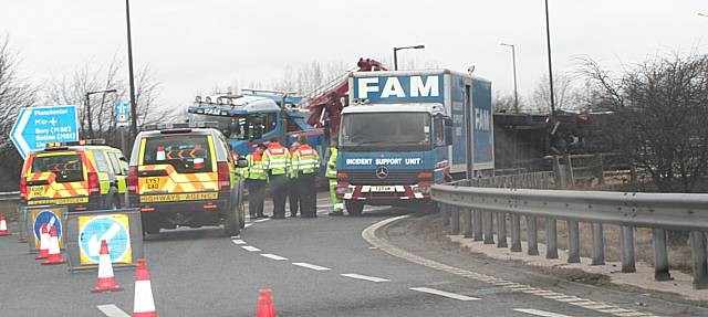 Highways officers and a crew from the incident support unit work to clear the wreckage.