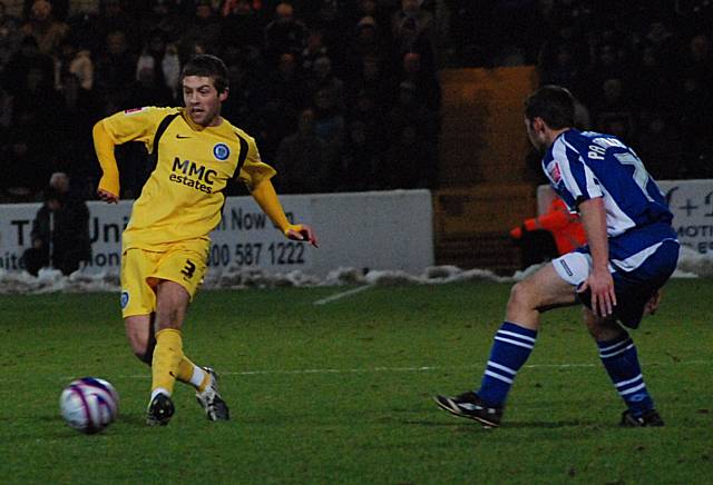 Tom Kennedy plays the ball forward.