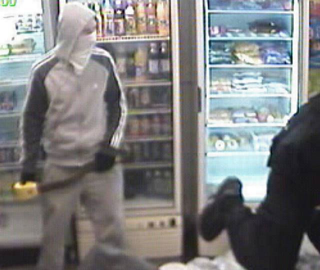 Ordeal: The young girl was pushed into a corner and threatened as masked robbers raided the newsagents