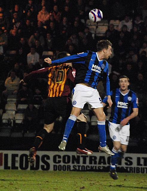 Clark Keltie goes for a header with Peter Thorne.