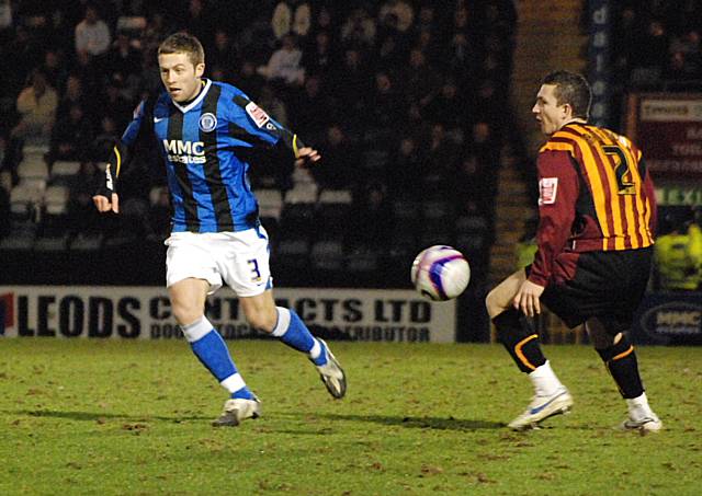 Tom Kennedy plays the ball forward.