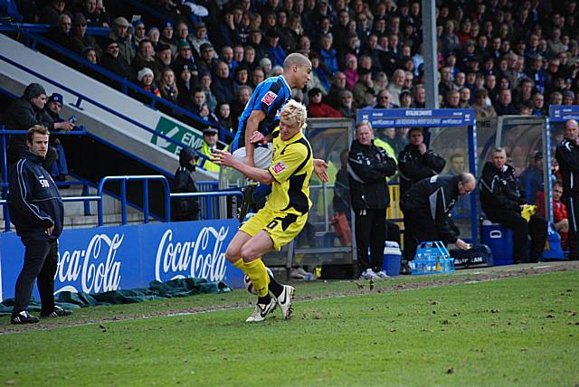 Taylor and Thompson battle for possession.