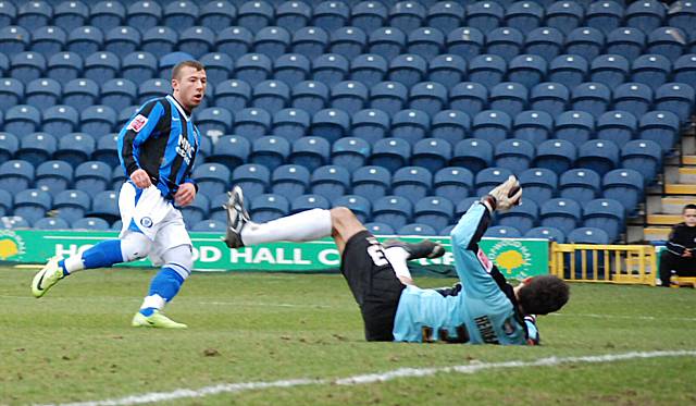 Le Fondre slides the ball beyond Wayne Henderson to double Dale's lead.