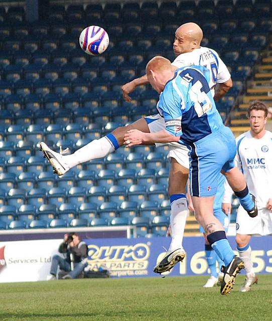 Thorpe and Holt challenge for a header.