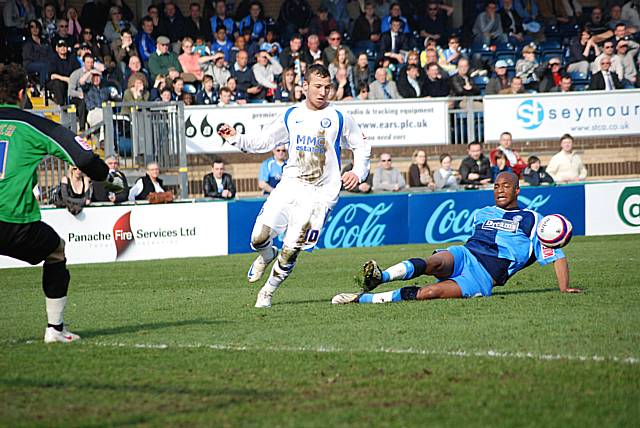 Le Fondre looks to beat Antwi into the box.