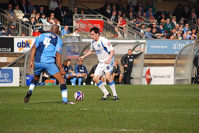 Chris Dagnall is faced by Johnson on the edge of the box.