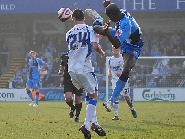 Leon Johnson tries to hurdle Dale striker Gary Madine!