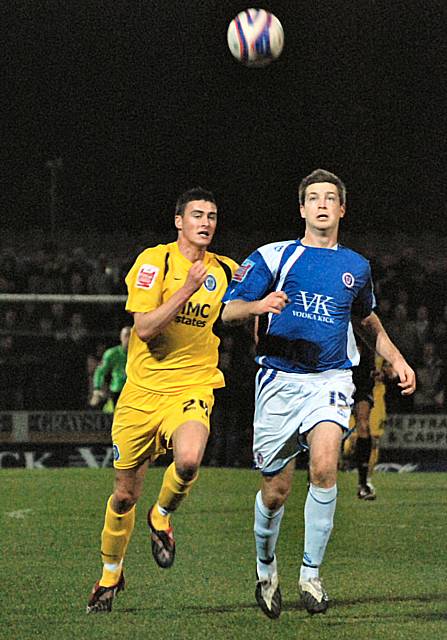 Gary Madine and Aaron Downes battle for possession.