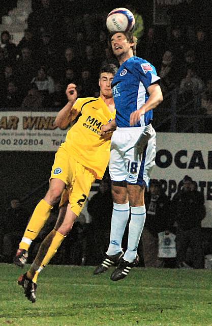 Danny Hall rises above Madine to nod a Dale corner clear.