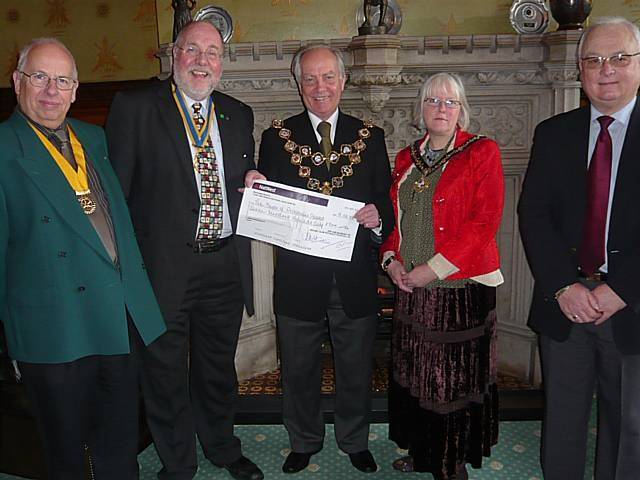 The Mayor is presented with a £700 cheque raised at the Nutter's Lunch.