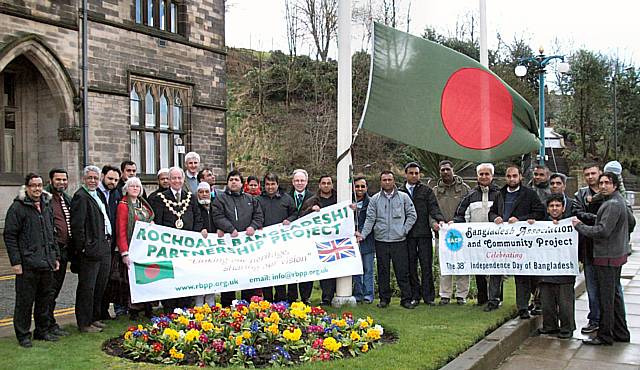 Local dignatories and members of the Bangladeshi community raise the flag at the town hall to celebrate Bangladesh's independence.