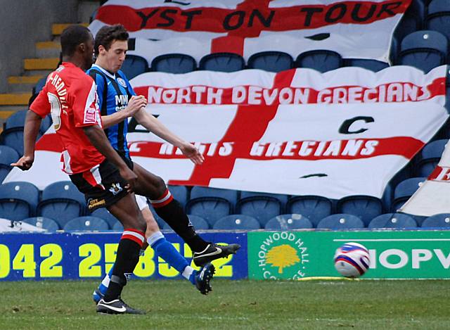 Troy Archibald-Henville clears ahead of Will Buckley.