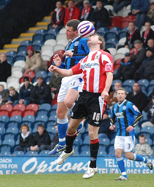 Rundle and Marcus Stewart go up for a header.